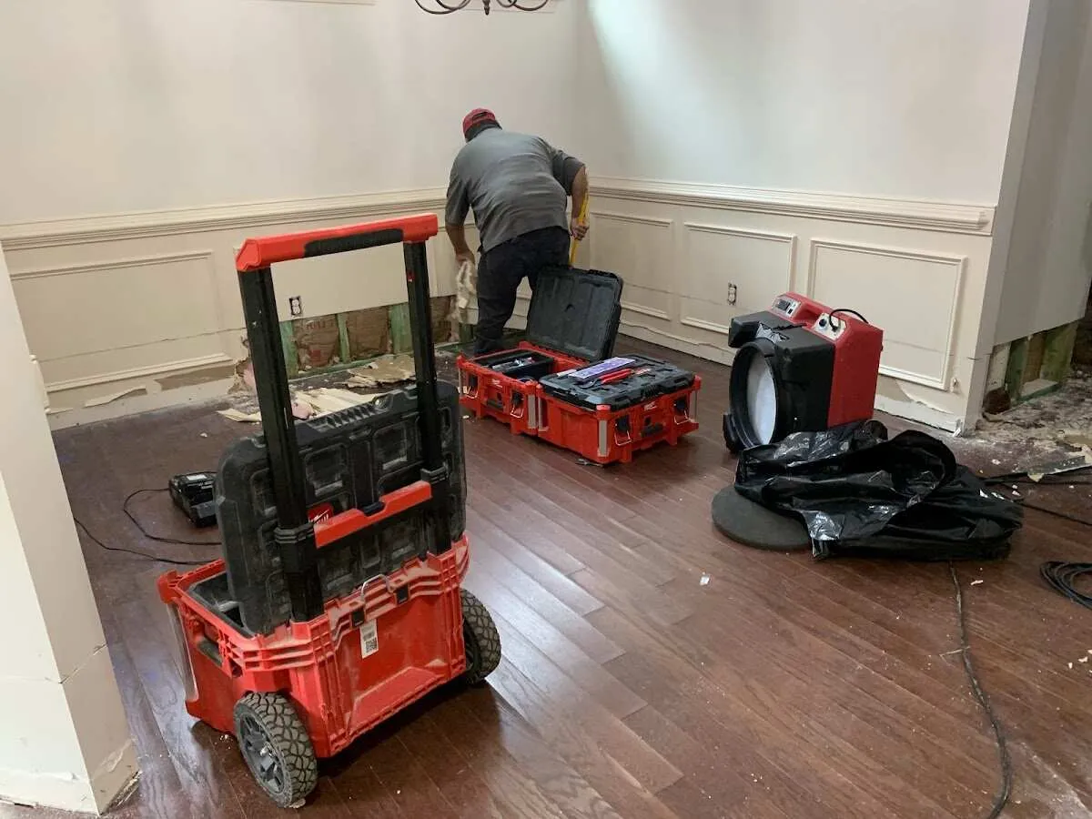 Technician setting up drying equipment for water damage in Wilmer